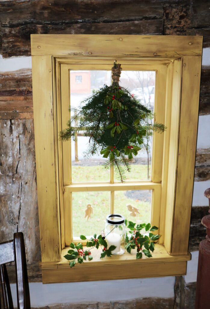 Window inside historic house decorated for Christmas